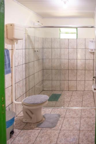 a bathroom with a toilet and a shower at Canto da cascata in Gramado
