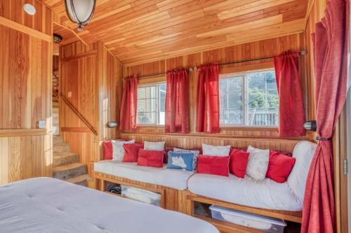 a room with two beds and red curtains at The Captains Place in Lincoln City