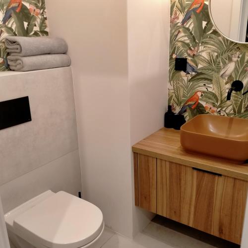 a bathroom with a toilet and a sink at Silesia Park Apartaments in Katowice