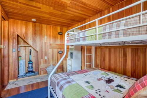 a bedroom with a bunk bed and a staircase at The Captains Place in Lincoln City