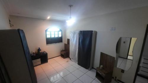 a bathroom with a shower and a sink and a mirror at Casa Ilha de Vera Cruz - Bahia in Vera Cruz de Itaparica
