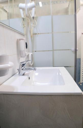 a bathroom with a white sink and a mirror at Mi Casa Affittacamere in Osio Sotto