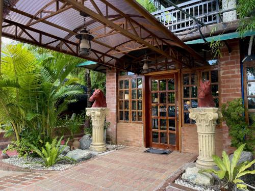 a building with two statues in front of it at Pook ni Urduja Resort 
