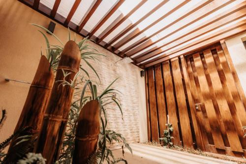 a room with a wooden fence and a plant at Golf du Rova Luxury Hotel in Antananarivo