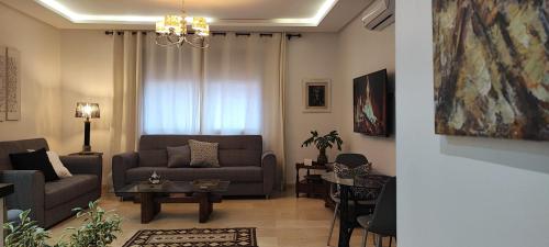 a living room with a couch and a table at Luxury Apartment in Hivernage Marrakech in Marrakech