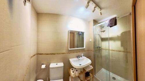 a bathroom with a sink and a toilet and a shower at Mimosa 7 - tucasaenlospirineos in Escarrilla