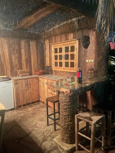 a kitchen with a stone counter top in a room at Magnifique Chalet en bois collé à la forêt de Benslimane in O Ben Slimane