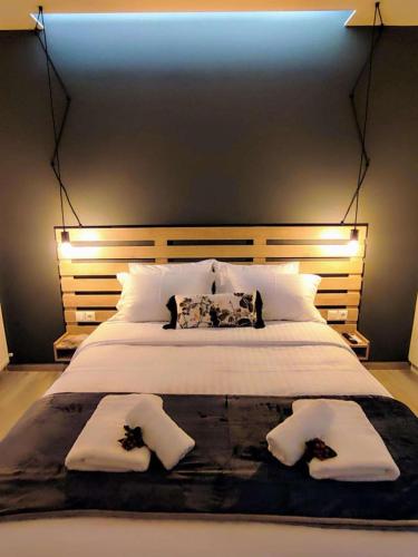 a bedroom with a large white bed with two people on it at Aneira Suite in Chalkida in Chalkida