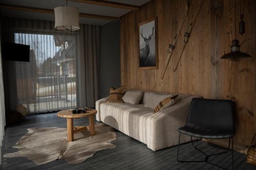a living room with a couch and a table at Gorczański Lux Chalet in Szlembark