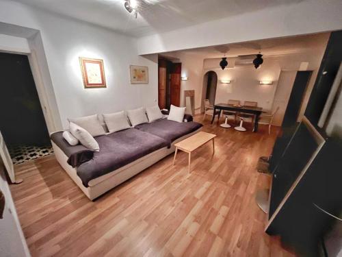a bedroom with a large bed and a living room at Casa Limón in Palma de Mallorca