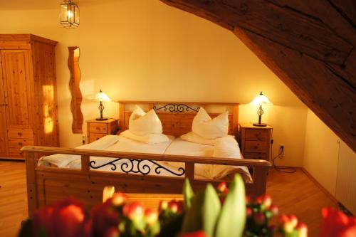 a bedroom with a bed with white sheets and pillows at Hotel zur Post in Herrsching am Ammersee