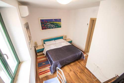 a bedroom with a bed and a painting on the wall at Apartments Umag Center, seafront with terrace in Umag in Umag