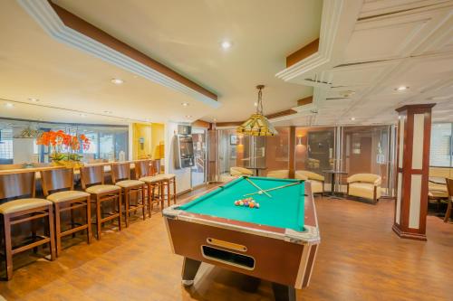 a pool table in a room with a bar at Boca Plaza in Boca Raton