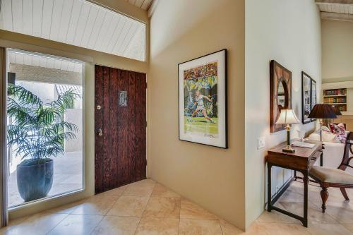 a living room with a door and a table at Elegant Lakeside Villa in Rancho Mirage