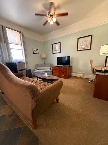 a living room with a couch and a ceiling fan at The Gadsden Hotel in Douglas