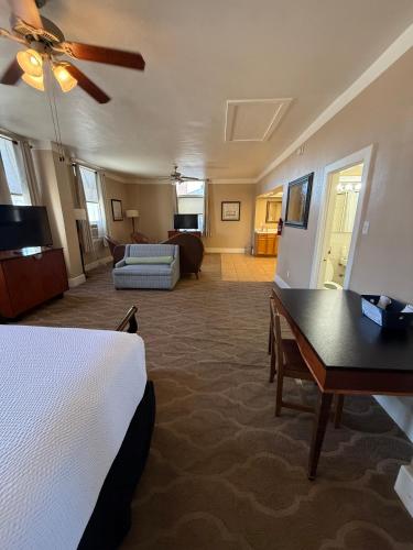 a hotel room with a bed and a living room at The Gadsden Hotel in Douglas