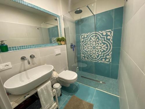 a bathroom with a sink and a toilet and a shower at Brezza sul Mare in Polignano a Mare