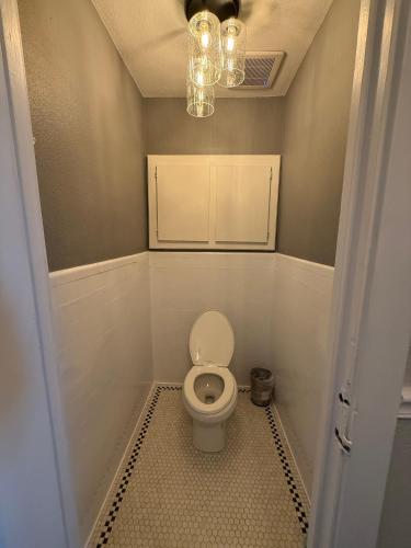 a bathroom with a white toilet in a room at The Gadsden Hotel in Douglas