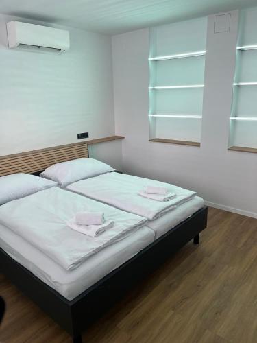 a bedroom with a bed with two towels on it at IQ Apartments in Prešov