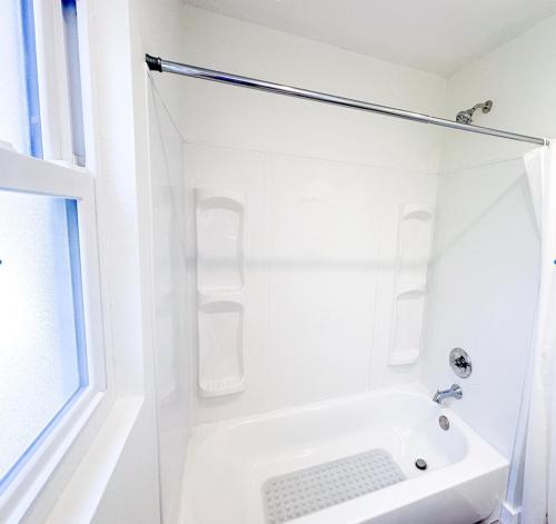 a white bathroom with a shower and a sink at Heated Salt Pool, Arcade, 2 Kings, Near Ami, Img in Bradenton