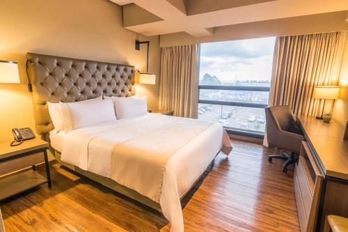 Postel nebo postele na pokoji v ubytování GHL Hotel Bogota Occidente