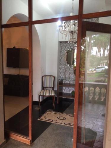 a living room with a chair and a glass door at desativado in Sao Jose do Rio Preto