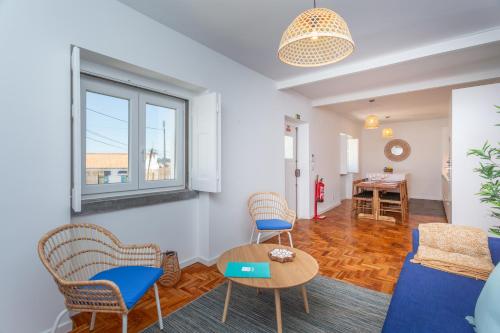 a living room with a blue couch and chairs at BeGuest Cascais Blue Family Home in Cascais