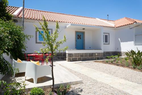 a white house with a blue door at BeGuest Cascais Blue Family Home in Cascais