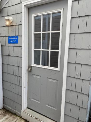 a door to a house with a sign on it at Riverview in Saugatuck