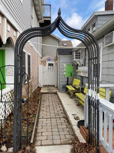 a patio with a gate and benches in front of a house at Riverview in Saugatuck