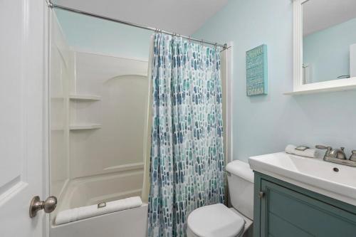 a bathroom with a shower and a toilet and a sink at Riverview in Saugatuck