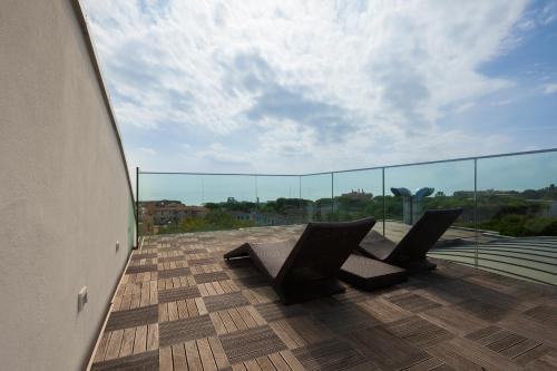a balcony with two chairs on top of a building at Hotel Ca' Di Valle in Cavallino-Treporti