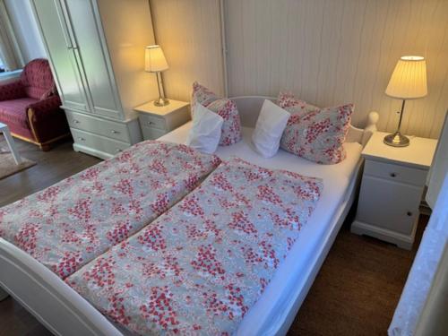 a bedroom with a bed and two night stands with lamps at Haus Sonnenschein in Zingst in Zingst