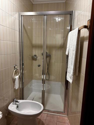 a bathroom with a shower and a sink at Residencial Real - Antiga Rosas in Vila Real