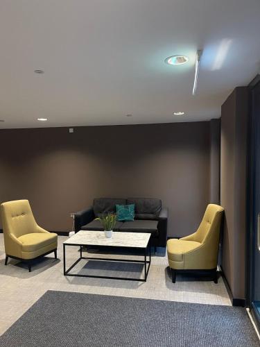 a living room with a couch and two chairs at York Central Stylish Flat - Sleeps 8 - Parking - Gym in York