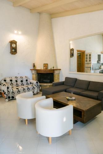 a living room with a couch and a table at villa eri in Kalamákion