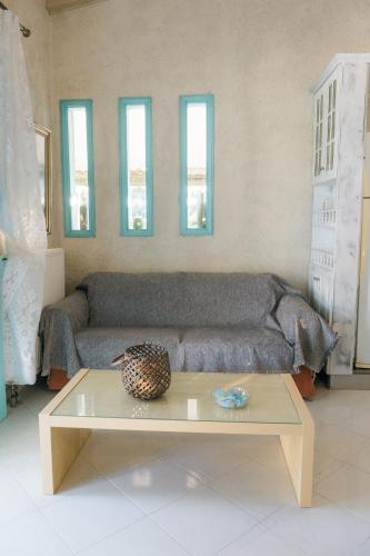 a living room with a couch and a table at villa eri in Kalamákion