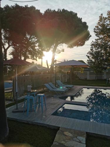 a patio with a table and chairs and a pool at villa eri in Kalamákion