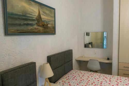 a bedroom with a bed and a sink and a mirror at villa eri in Kalamákion