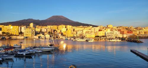 a group of boats in a harbor with a city at Antica resina Appartamento Scavi in Ercolano