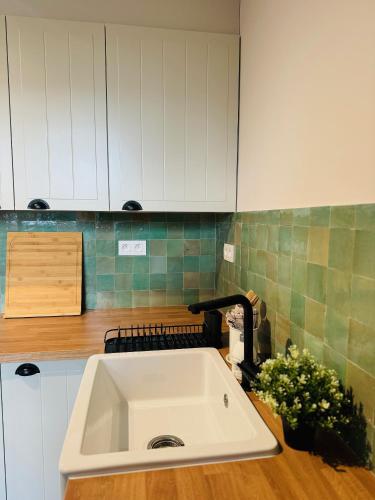 a kitchen counter with a sink in a kitchen at Two bedroom apartment 150m from the beach in De Haan