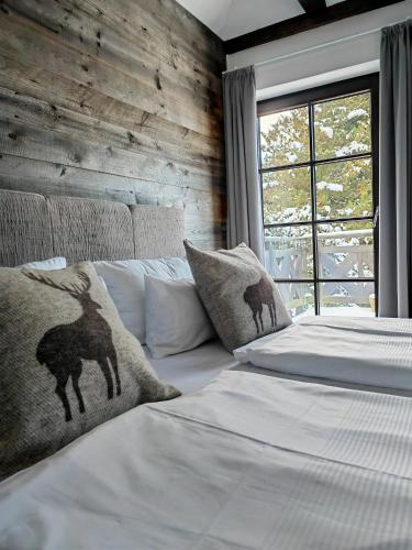 a bedroom with a bed with white sheets and a window at Pension Kleiner König in Struppen-Siedlung