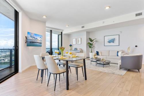 a dining room and living room with a table and chairs at Downtown by Miami Vacation Rentals in Miami