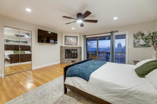 ein Schlafzimmer mit einem Bett und einem Kamin in der Unterkunft Cincinnati Home, Patio with Downtown Views! in Cincinnati