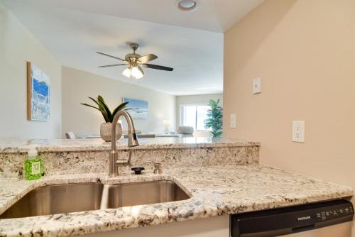 a kitchen with a sink and a ceiling fan at Walk to Bradenton Beach Gulf-View Home with Lanai in Bradenton Beach