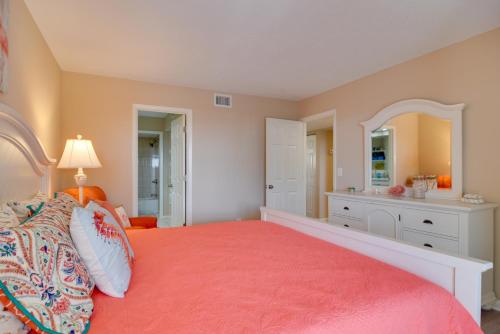 a bedroom with a large bed with a red bedspread at Walk to Bradenton Beach Gulf-View Home with Lanai in Bradenton Beach