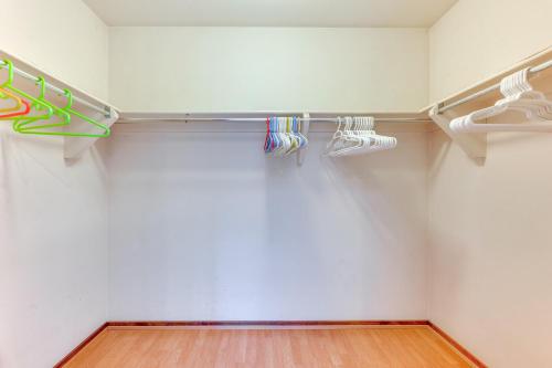 a walk in closet with white walls and wooden floors at 2 Mi to CU Boulder Townhome with Private Deck! in Boulder