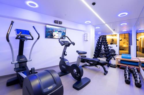 a gym with several tread machines in a room at SIGMA Suites Hotel in Thessaloniki