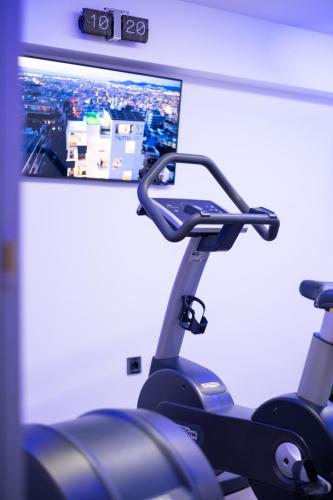 a gym with a monitor and a treadmill at SIGMA Suites Hotel in Thessaloniki