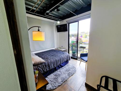 a small bedroom with a bed and a balcony at C46-R07 STUDIOS at ITESM CEM Families Tourists & Travelers Choice Foreign Students Companies Executives WELCOME!!! 10min Izcalli-15min Esmeralda-20min Sátelite-25min AIFA in Mexico City